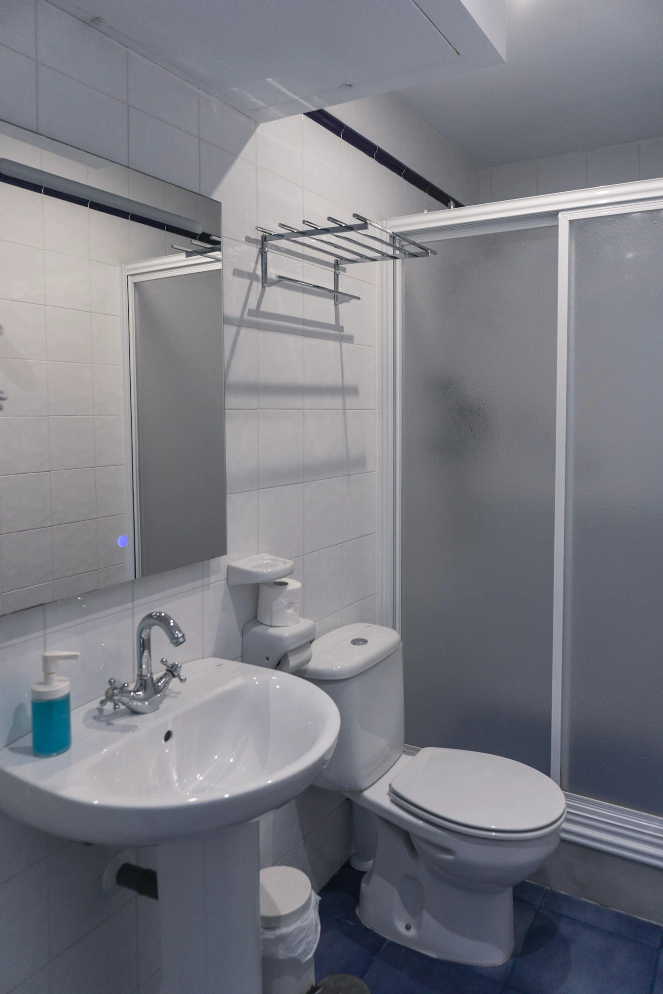 white tiled bathroom and shower